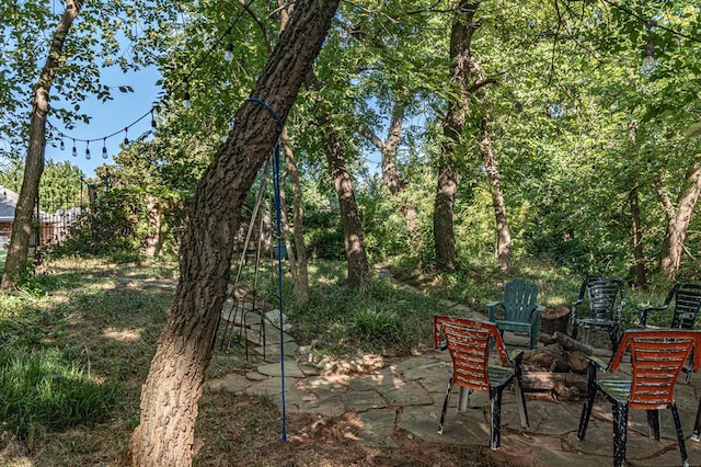 view of yard featuring a patio and a fire pit