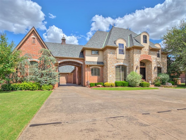 french country style house with a front lawn