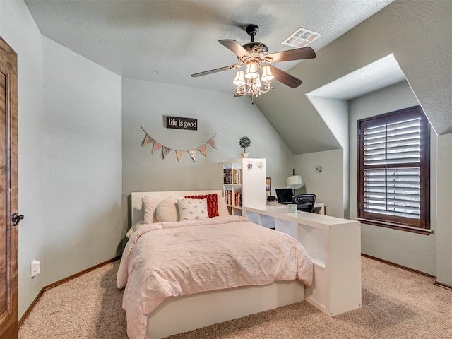 carpeted bedroom with a textured ceiling, ceiling fan, and vaulted ceiling