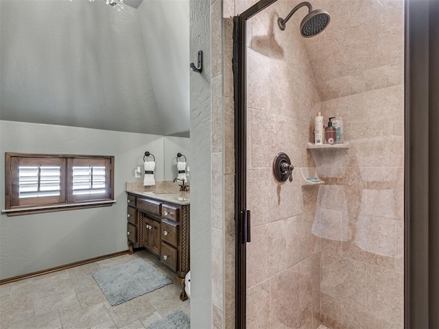 bathroom featuring vaulted ceiling, vanity, and an enclosed shower