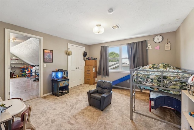 bedroom with light carpet and a closet