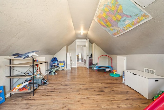 game room featuring hardwood / wood-style floors and lofted ceiling