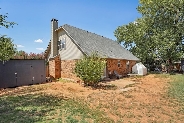 back of house with a lawn and a storage shed