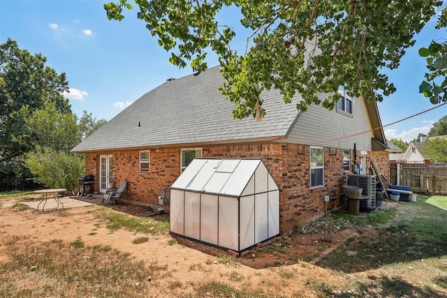 rear view of house with a patio and cooling unit