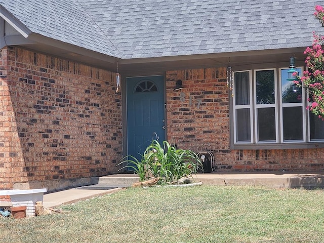 doorway to property featuring a yard