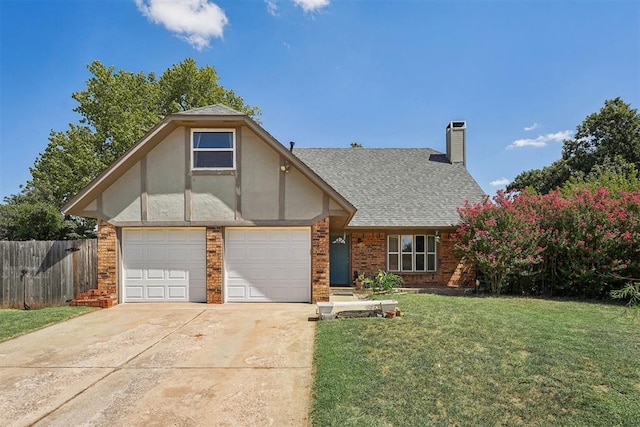 tudor-style house featuring a garage and a front lawn