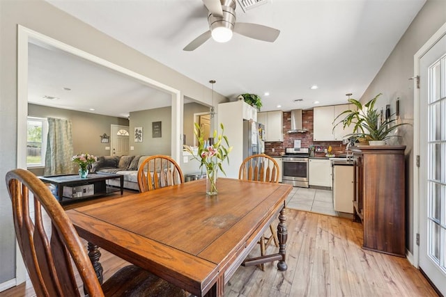 dining space featuring light hardwood / wood-style floors and ceiling fan