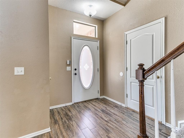 entrance foyer with a textured ceiling and dark wood-type flooring