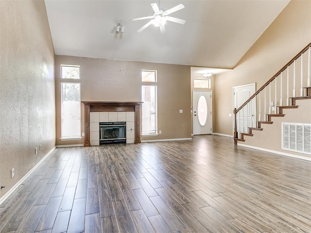 unfurnished living room featuring hardwood / wood-style flooring, a fireplace, and a wealth of natural light