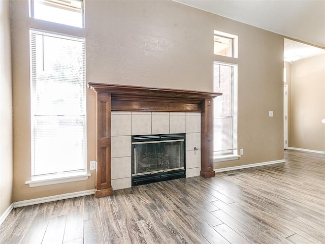 unfurnished living room with a fireplace and light wood-type flooring