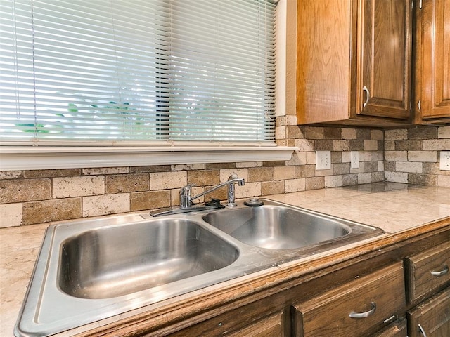 kitchen featuring tasteful backsplash and sink