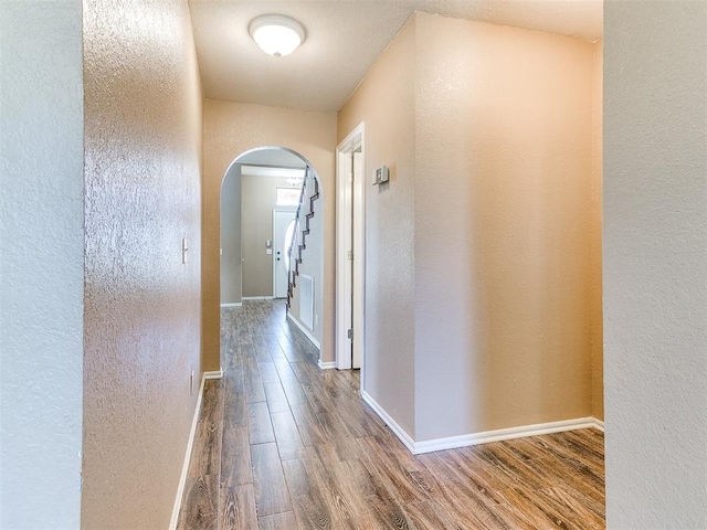 hallway with hardwood / wood-style floors