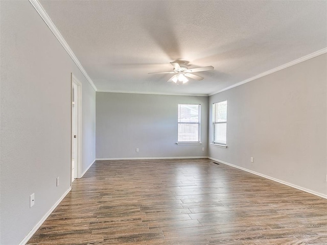 empty room featuring dark hardwood / wood-style floors, ceiling fan, ornamental molding, and a textured ceiling