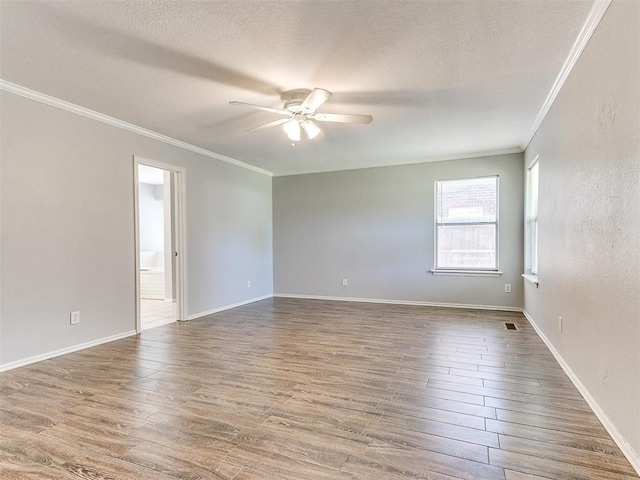 unfurnished room with hardwood / wood-style flooring, ceiling fan, ornamental molding, and a textured ceiling