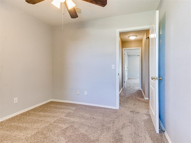 empty room with ceiling fan and light colored carpet