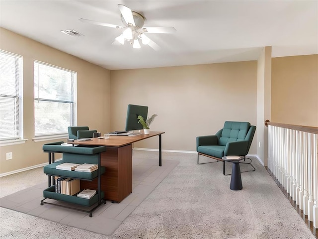 home office featuring light carpet and ceiling fan