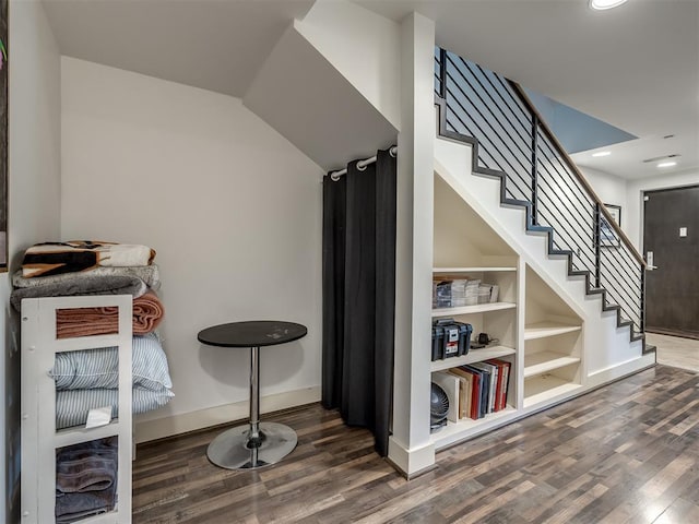 staircase with hardwood / wood-style flooring