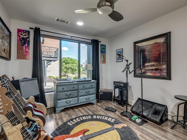 living area with ceiling fan and hardwood / wood-style flooring