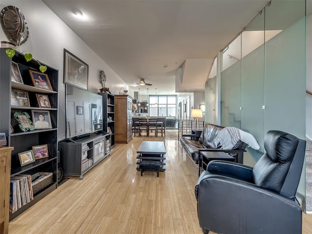 living room with ceiling fan and light hardwood / wood-style floors