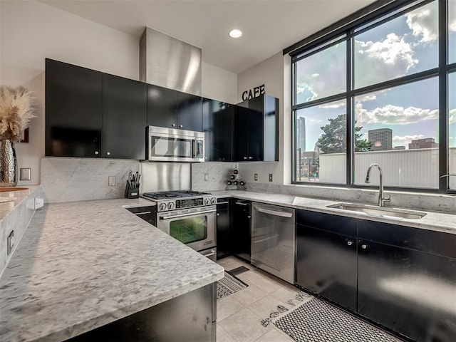 kitchen with sink, stainless steel appliances, tasteful backsplash, light stone counters, and light tile patterned floors