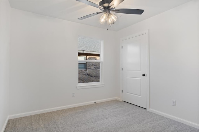 carpeted empty room featuring ceiling fan