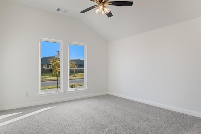 carpeted spare room with ceiling fan and vaulted ceiling