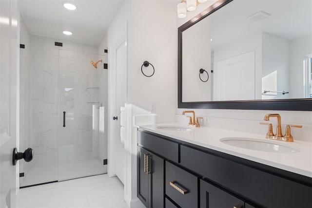 bathroom with vanity and a shower with shower door