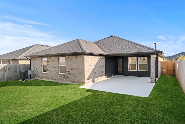 rear view of house featuring a patio, a lawn, and central air condition unit