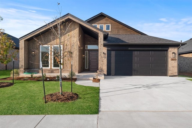 view of front of property featuring a front yard and a garage