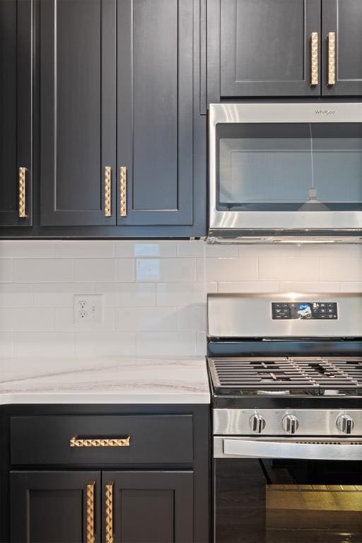 kitchen with stainless steel appliances and tasteful backsplash