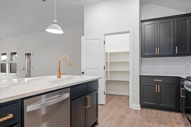 kitchen featuring light wood-type flooring, stainless steel dishwasher, vaulted ceiling, sink, and decorative light fixtures