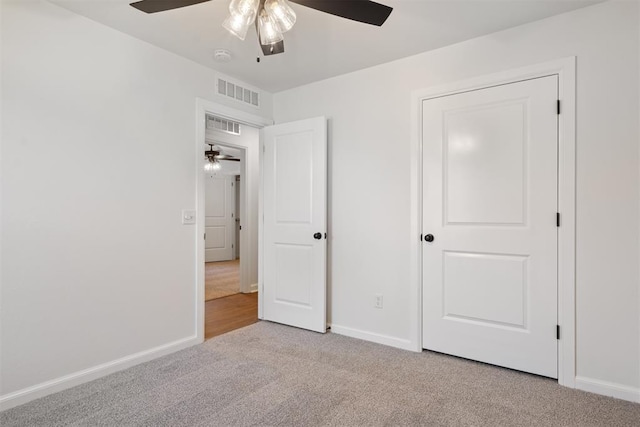 unfurnished bedroom featuring ceiling fan and light carpet