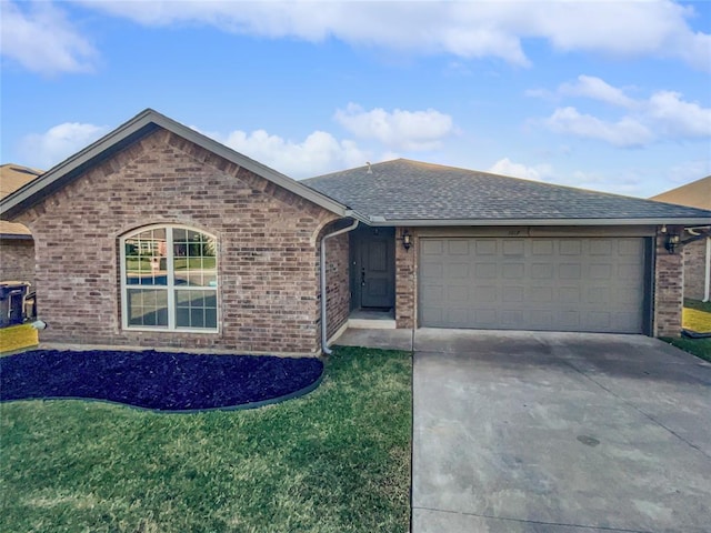 single story home with a garage and a front lawn