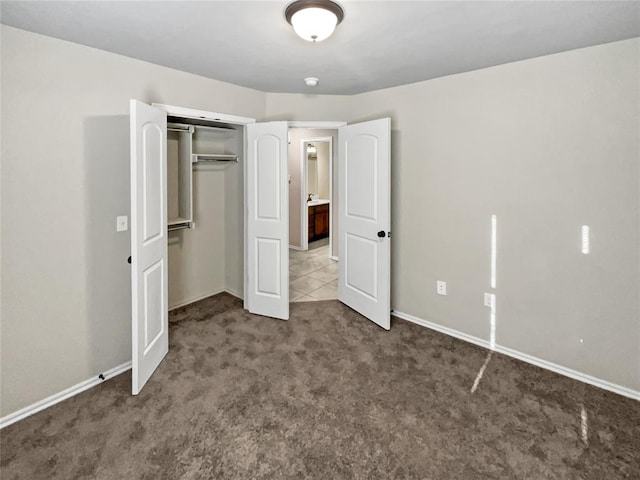 unfurnished bedroom featuring carpet floors and a closet