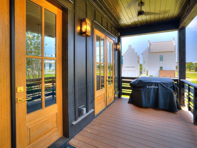 wooden terrace with a porch and grilling area