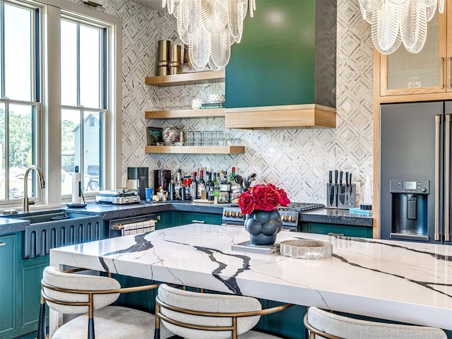 kitchen featuring dark stone countertops, plenty of natural light, and a notable chandelier