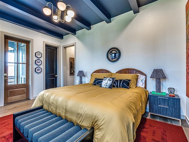 bedroom featuring dark hardwood / wood-style flooring and beamed ceiling