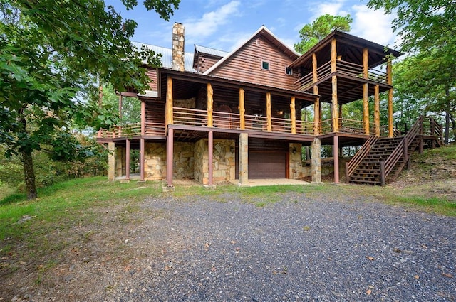 view of front facade featuring a deck and a garage