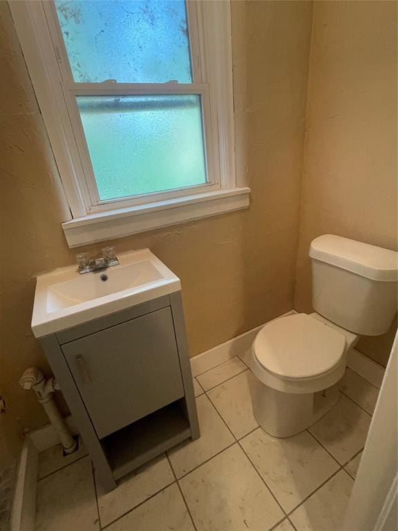 bathroom featuring tile patterned flooring, vanity, and toilet