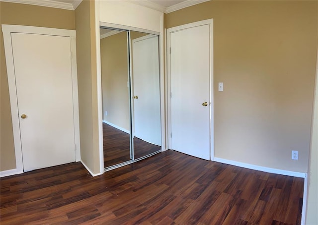 unfurnished bedroom with dark hardwood / wood-style flooring and crown molding