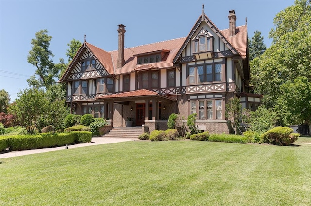 tudor home with a front lawn