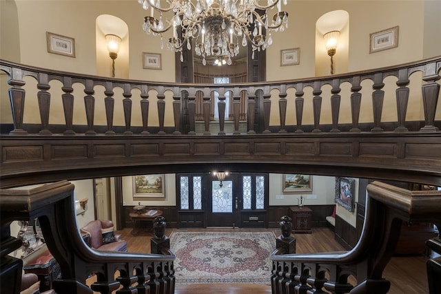 interior space featuring hardwood / wood-style floors, a high ceiling, and a notable chandelier