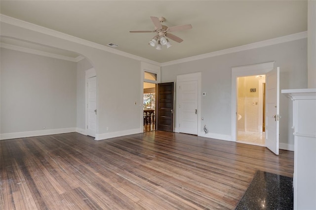 empty room with crown molding, dark hardwood / wood-style flooring, and ceiling fan