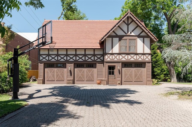 tudor-style house with a garage