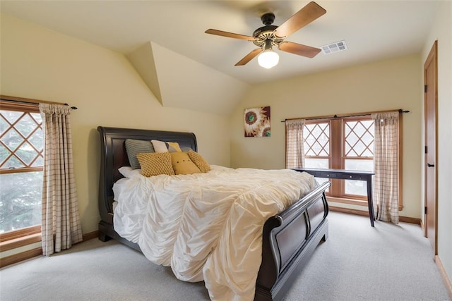 carpeted bedroom featuring vaulted ceiling, multiple windows, and ceiling fan