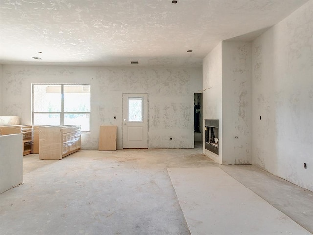 unfurnished living room featuring a fireplace