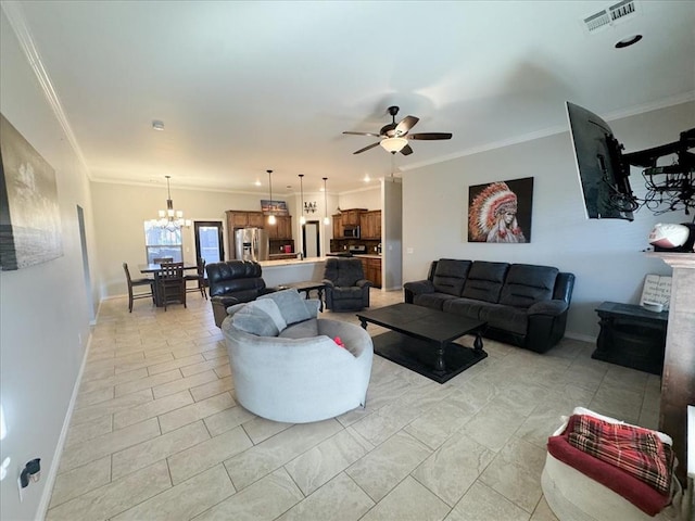 living room with ceiling fan with notable chandelier and ornamental molding