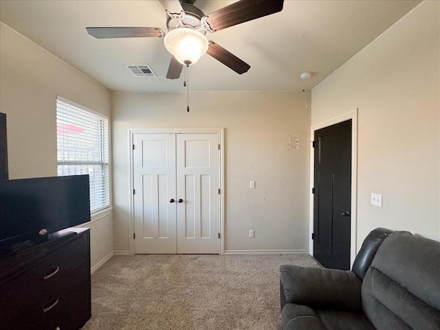 sitting room with light colored carpet and ceiling fan