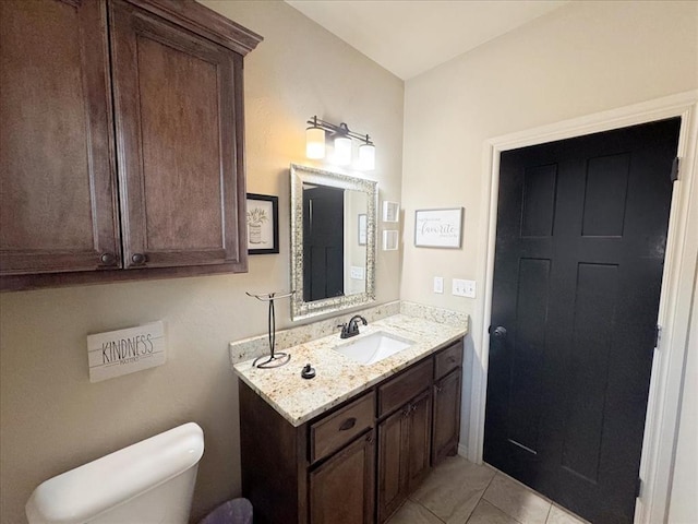 bathroom featuring tile patterned floors, vanity, and toilet