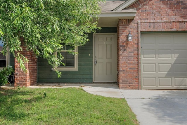 1017 SW 91st St, Oklahoma City, OK 73139 - doorway to property with brick siding, an attached garage, and driveway